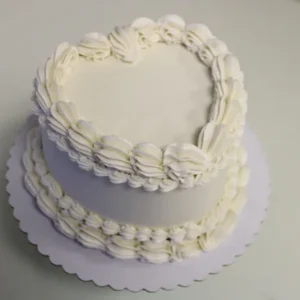 Elegant white heart cake on table