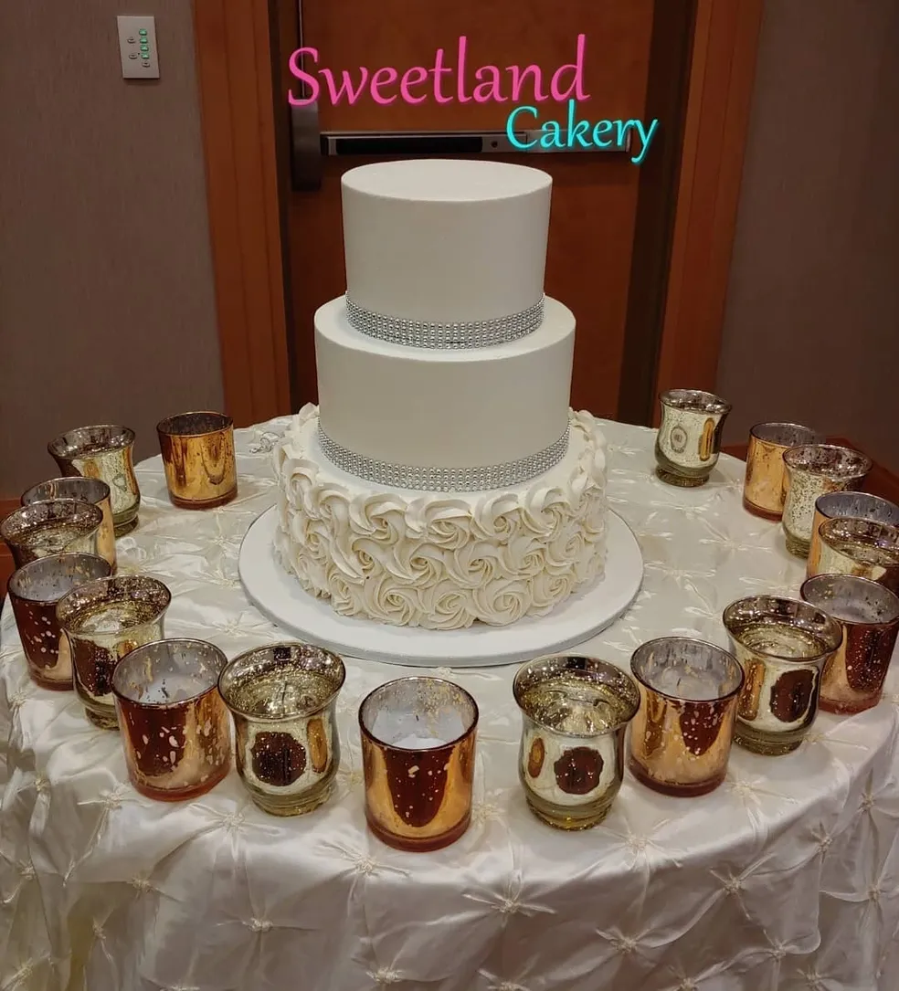 White tiered cake with candles