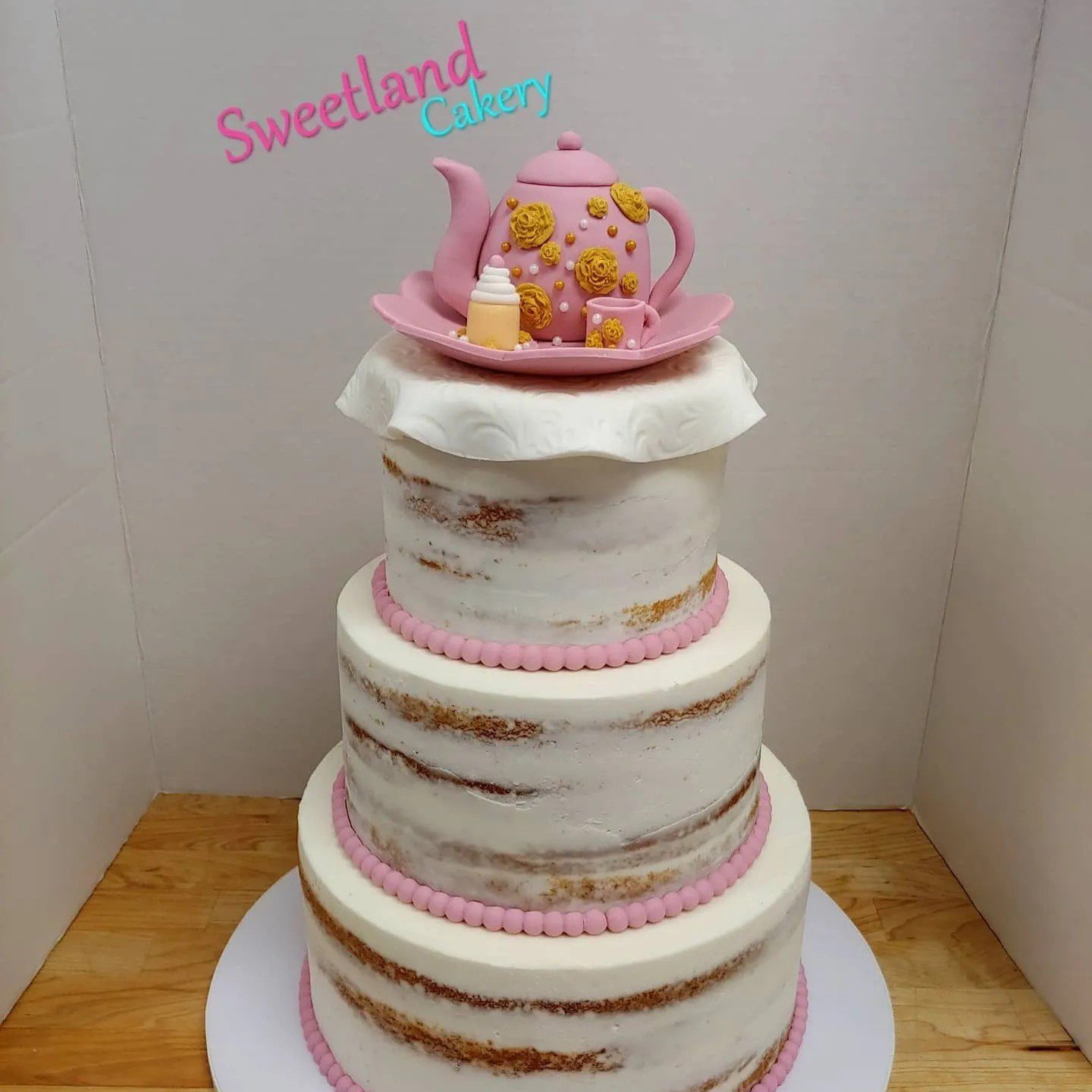 Naked cake decorated with pink accents